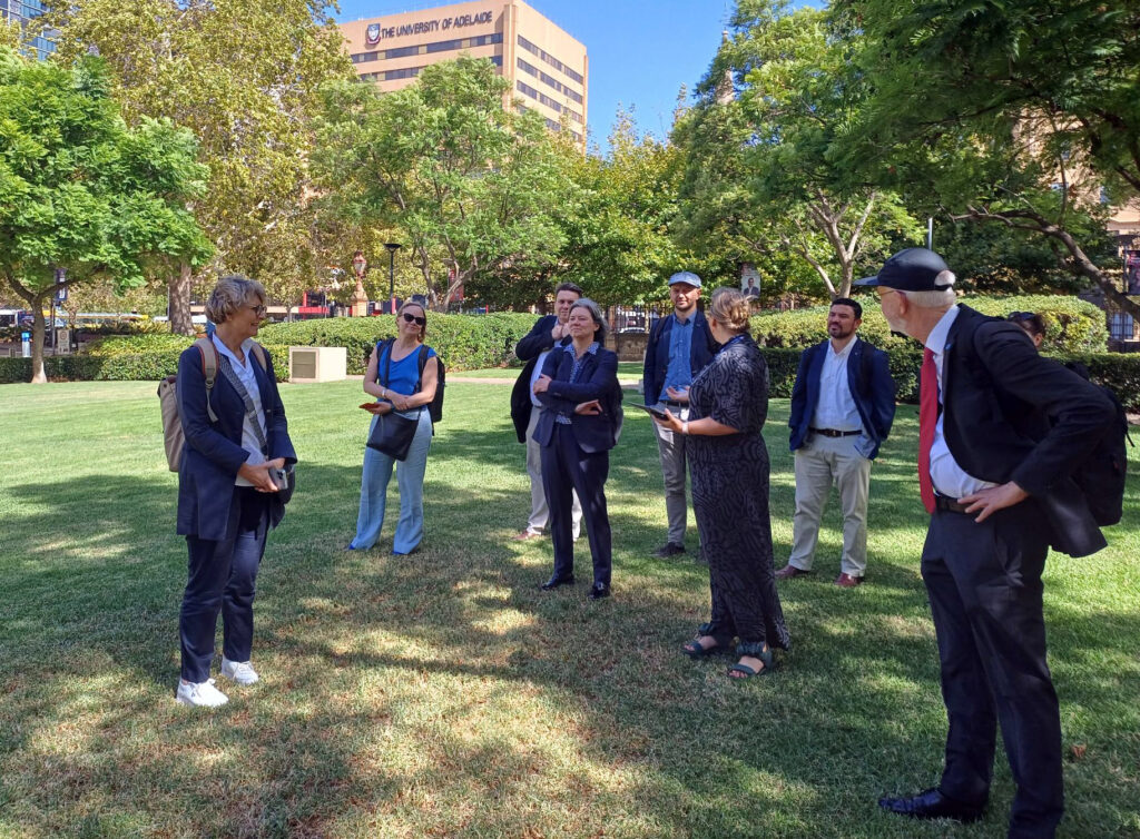
Several people are talking on a meadow.