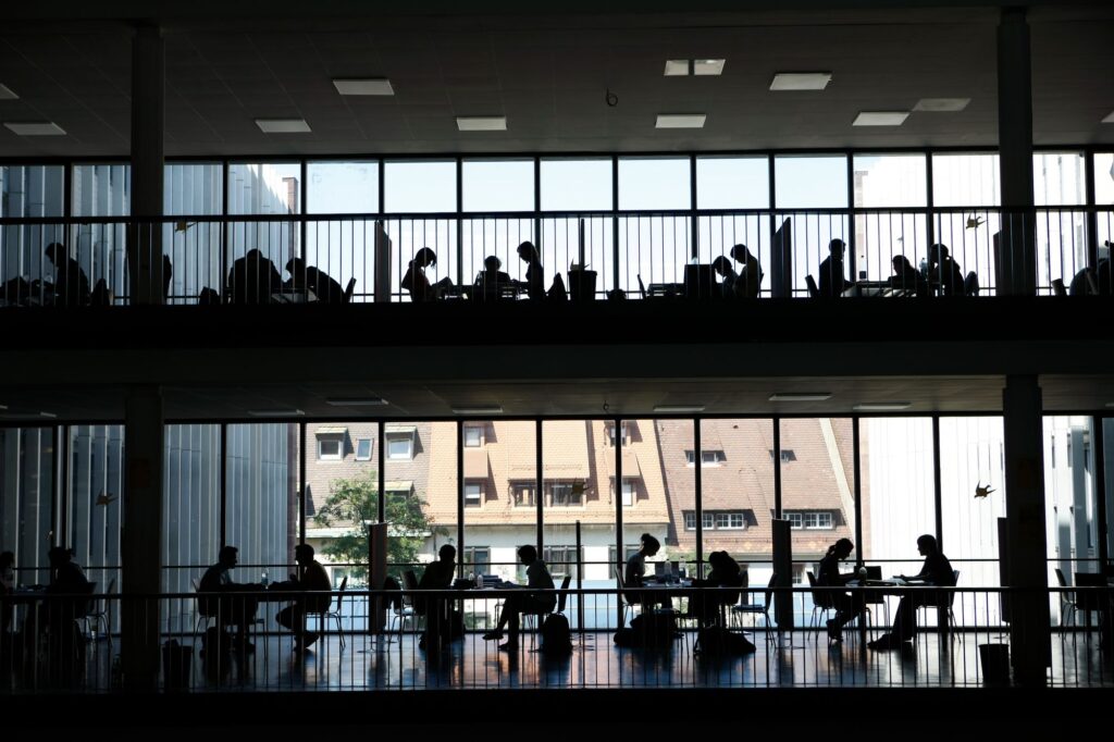 Silhoettes of students in Front of a window.