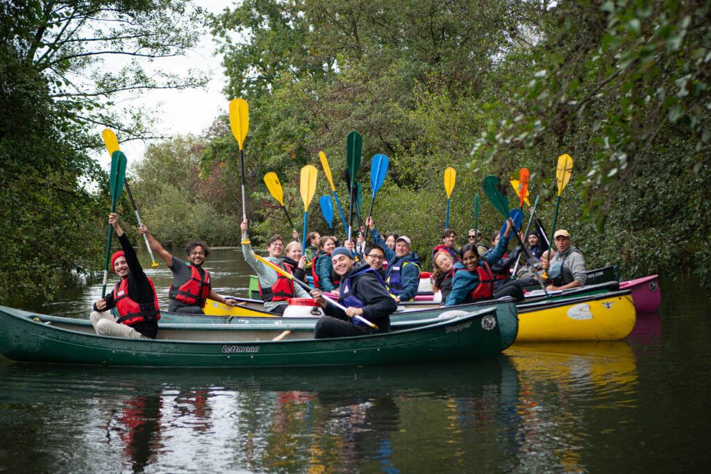 Students and doctoral candidates in kayaks