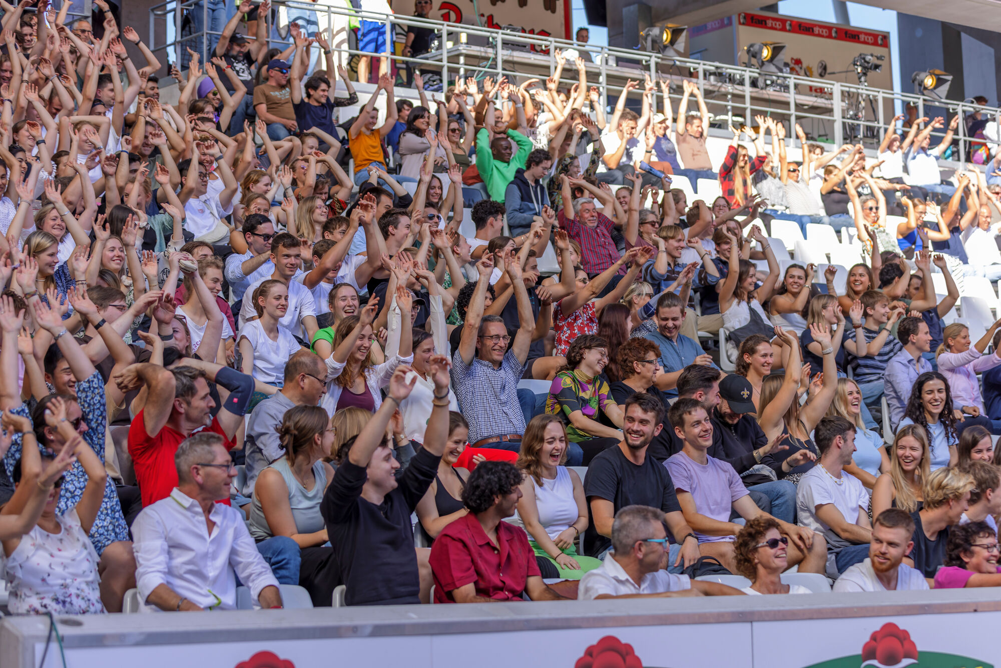 Visitors to the University of Freiburg's Semester Welcome in the stands of the SC Freiburg stadium.