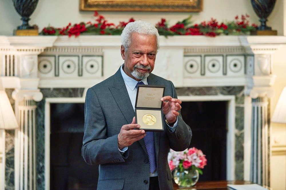 A man presenting a medal.