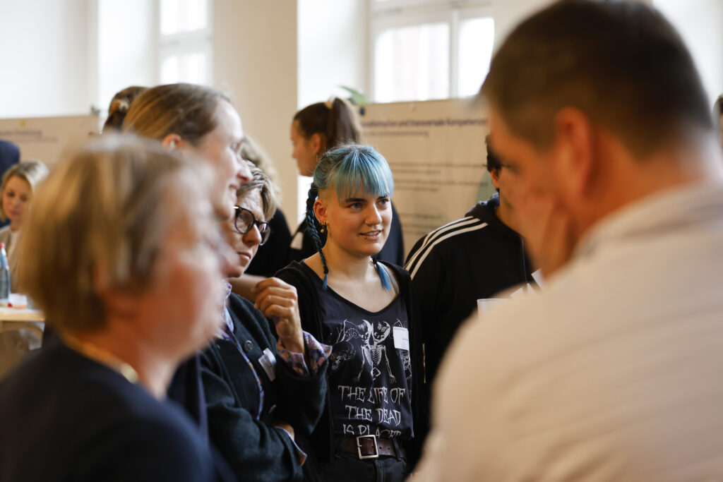 A group of people talking to each other.