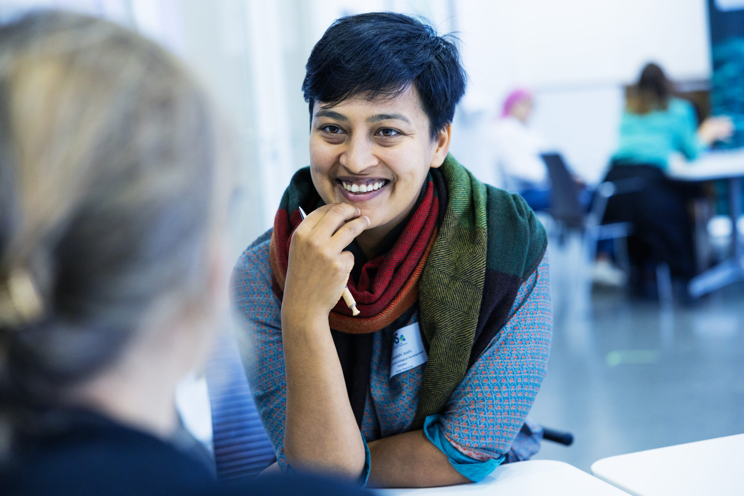 Scholar in the FRIAS smiling friendly seminar room