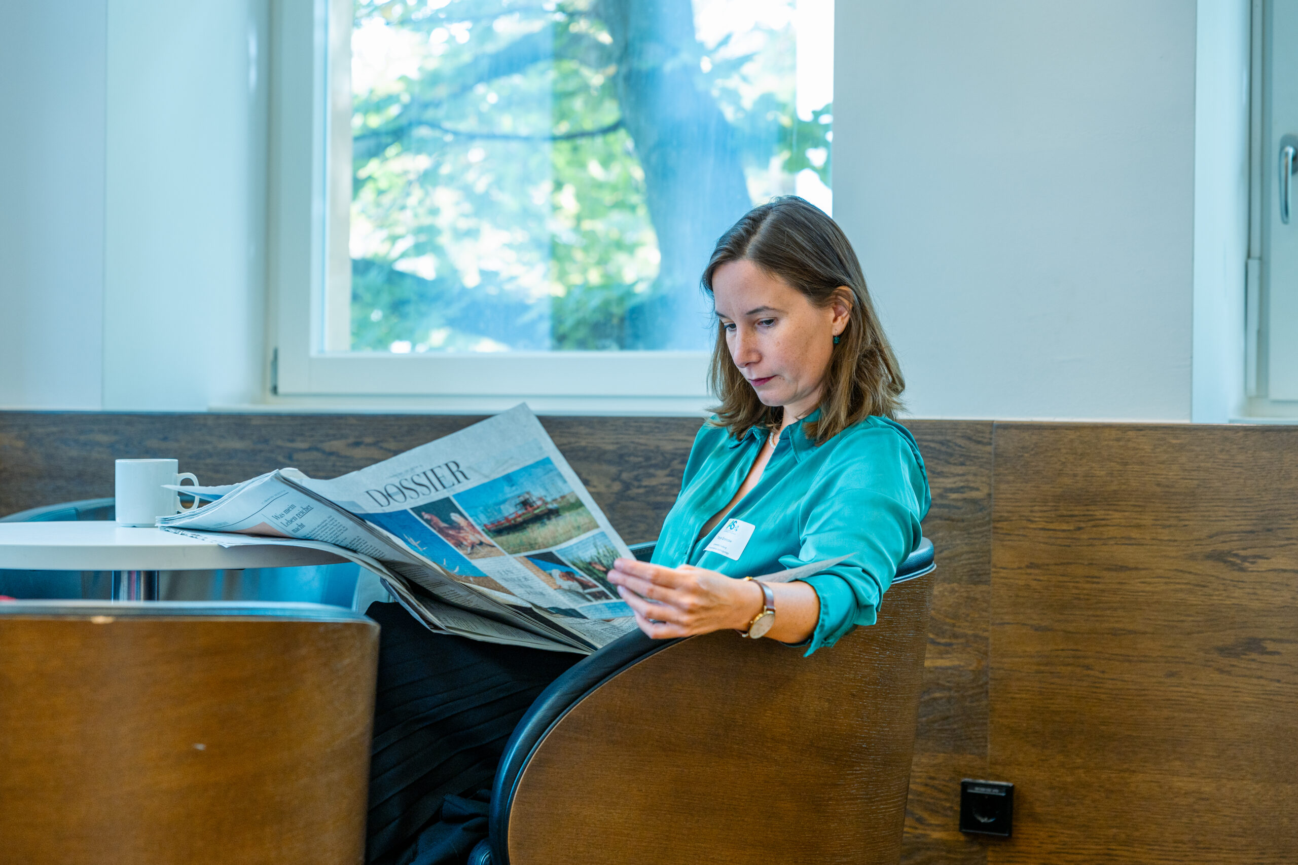 Woman reading Newspaper in the FRIAS Lounge