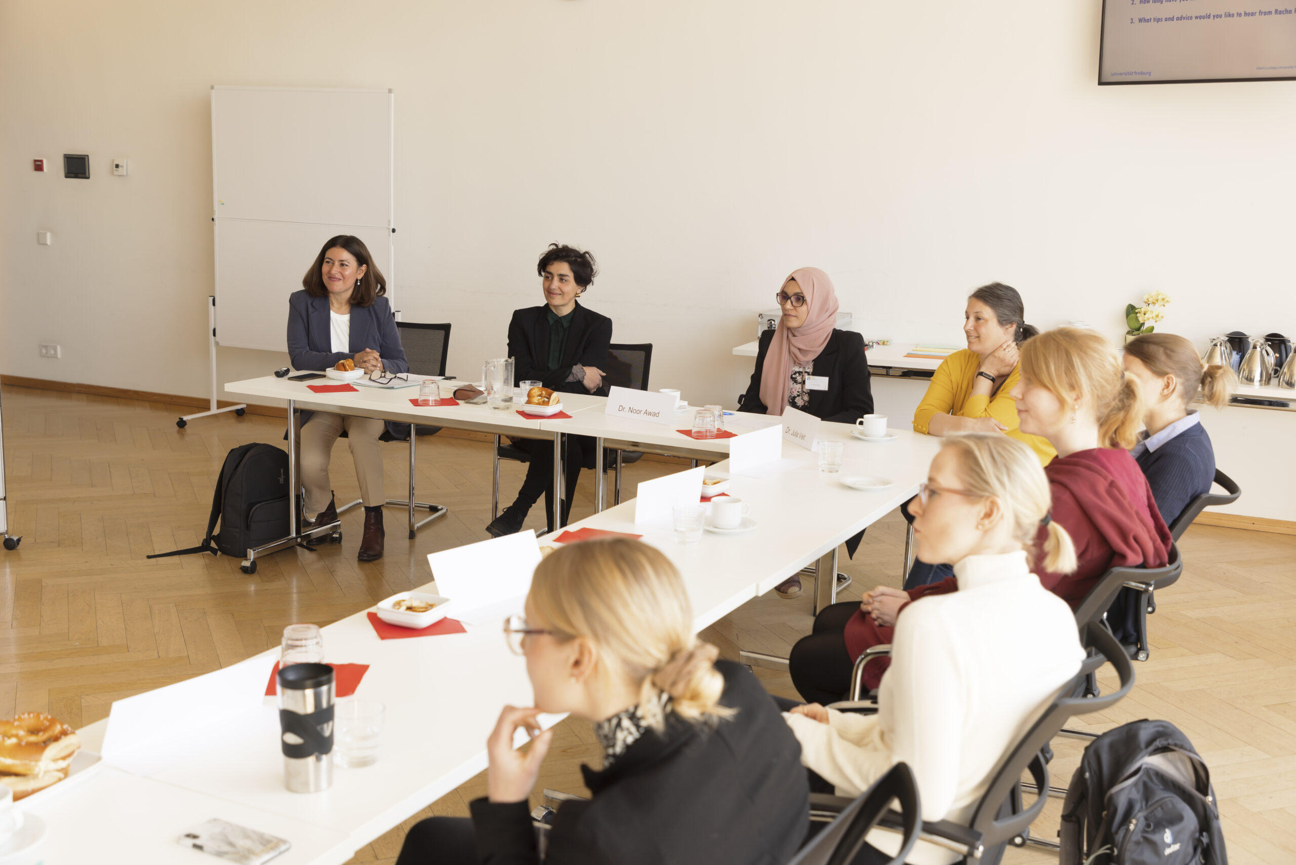 Small group of female researchers in conversation.