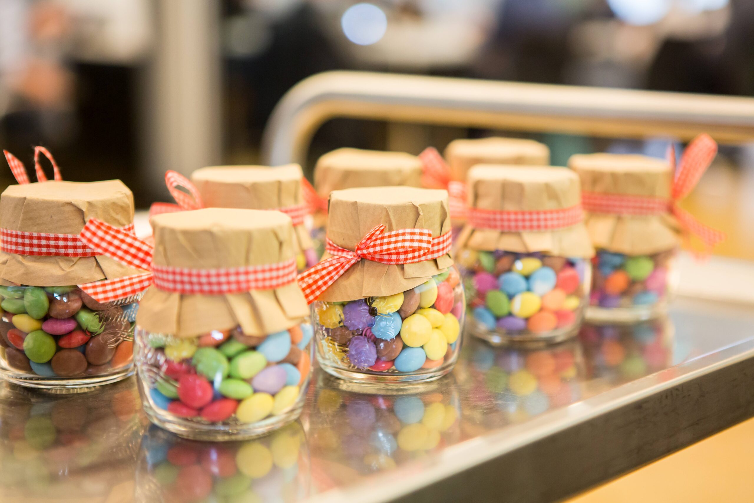 Colourful chocolate lentils in jars.