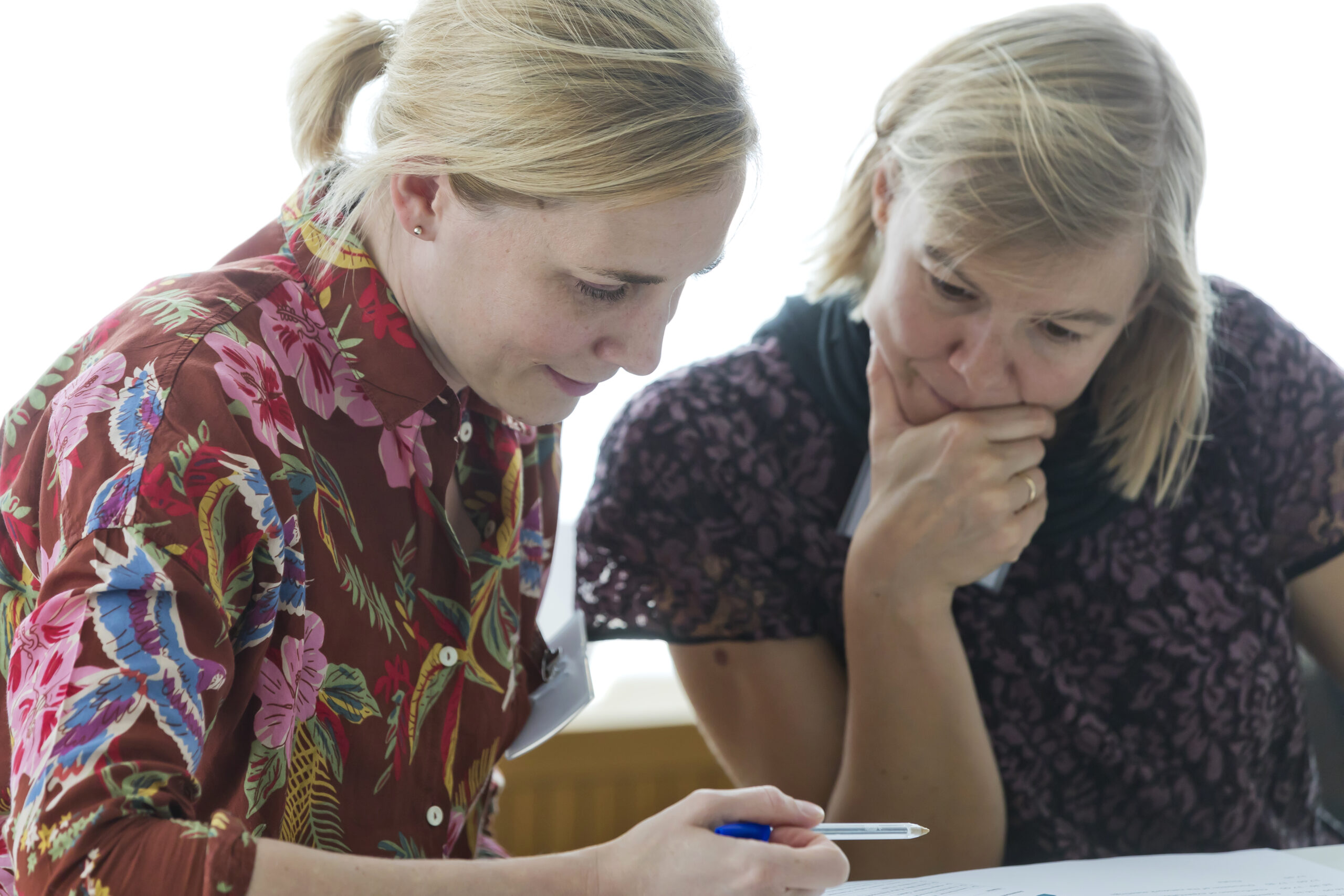 Female researchers thinking and working together.