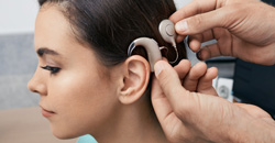 Cochlear implant. Installation cochlear implant on woman’s ear for restores hearing